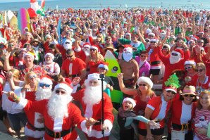 Várias centenas de &quot;Pais Natal&quot; celebraram o Surfing Santa Day em Cocoa Beach, Flórida